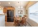 Charming dining area features wood table set, chandelier, and kitchen access at 40569 N Wedge Dr, San Tan Valley, AZ 85140
