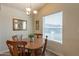 Cozy dining area with wood table set, chandelier, and window providing natural light at 40569 N Wedge Dr, San Tan Valley, AZ 85140