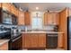 Bright kitchen featuring wooden cabinets, granite countertops, and stainless steel appliances at 40569 N Wedge Dr, San Tan Valley, AZ 85140