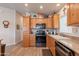 Well-equipped kitchen boasts wooden cabinets and stainless steel appliances at 40569 N Wedge Dr, San Tan Valley, AZ 85140