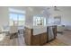 Kitchen featuring a farmhouse sink, stainless steel dishwasher, and ample natural light from the large windows at 40724 N Capital Ct, Anthem, AZ 85086