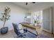 Home office featuring a rustic wooden desk, a comfortable chair, and natural light from the sliding glass doors at 40724 N Capital Ct, Anthem, AZ 85086