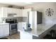 Bright kitchen with stainless steel appliances, granite countertops, and white cabinets at 419 E Gemini Dr, Tempe, AZ 85283