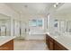 Bright bathroom with double vanity, glass enclosed shower, and soaking tub at 42209 N 46Th Ln, Phoenix, AZ 85086
