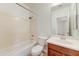 Bright bathroom featuring a shower-tub combination and a classic vanity with a framed mirror at 42209 N 46Th Ln, Phoenix, AZ 85086