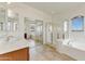Bright bathroom featuring double sinks, glass shower, and a soaking tub at 42209 N 46Th Ln, Phoenix, AZ 85086