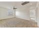 This room features plush carpeting, neutral paint and trim, and a beautiful window that offers plenty of natural light at 42209 N 46Th Ln, Phoenix, AZ 85086