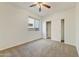 This room features plush carpeting, neutral paint and trim, and a beautiful window that offers plenty of natural light at 42209 N 46Th Ln, Phoenix, AZ 85086