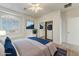 This bedroom features a large bed, closet with mirrored doors, and a beautiful window that offers plenty of natural light at 42209 N 46Th Ln, Phoenix, AZ 85086