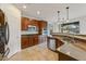 Updated kitchen features stainless appliances, granite counters, tile flooring, and ample cabinet space at 42209 N 46Th Ln, Phoenix, AZ 85086