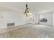 Open-concept living space with new carpet, decorative lighting, and natural light at 42209 N 46Th Ln, Phoenix, AZ 85086