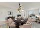Living room with round wooden table, stylish lighting fixture, and decorative rug at 42209 N 46Th Ln, Phoenix, AZ 85086
