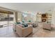 Bright living room featuring a stone fireplace, tile floors, and large windows with backyard views at 42209 N 46Th Ln, Phoenix, AZ 85086