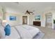 Spacious bedroom featuring soft carpet, ceiling fan, and ensuite bathroom at 42209 N 46Th Ln, Phoenix, AZ 85086