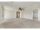 Bright bedroom with carpet flooring, ceiling fan, and access to the ensuite bathroom at 42209 N 46Th Ln, Phoenix, AZ 85086