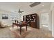 This office features a beautiful desk, a large window with natural lighting, and a bookcase that offers ample storage at 42209 N 46Th Ln, Phoenix, AZ 85086