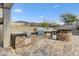 View of a well-equipped outdoor kitchen with a built-in grill and stone countertops at 42209 N 46Th Ln, Phoenix, AZ 85086