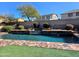 Backyard pool with decorative stone waterfall feature and lush landscaping, creating a serene outdoor oasis at 42209 N 46Th Ln, Phoenix, AZ 85086