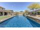 Spacious pool area with an outdoor kitchen and beautifully designed stone accents at 42209 N 46Th Ln, Phoenix, AZ 85086