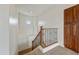 A staircase features ornate iron railing, wooden banisters, and built in cabinet storage for an added touch of elegance at 42209 N 46Th Ln, Phoenix, AZ 85086
