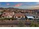 Aerial view of a backyard oasis: fenced pool, patio furniture, and desert landscape with sunset sky at 44610 N Sonoran Arroyo Ln, New River, AZ 85087