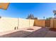 Enclosed backyard featuring a brick paver patio area and block wall for privacy at 4650 E Wood St, Phoenix, AZ 85040