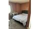 Serene bedroom featuring a comfortable bed, carpeted floors, and natural light at 4650 E Wood St, Phoenix, AZ 85040