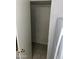 Walk-in closet with tiled floors and painted brick walls at 4650 E Wood St, Phoenix, AZ 85040