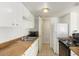 Functional kitchen with white cabinetry, laminate countertops, and essential appliances at 4650 E Wood St, Phoenix, AZ 85040