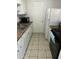 Kitchen featuring white appliances, countertops, and tiled floors at 4650 E Wood St, Phoenix, AZ 85040