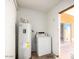 Utility room featuring a washing machine and water heater at 4650 E Wood St, Phoenix, AZ 85040