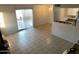 Open concept living room with tiled floors and glass sliding doors at 4650 E Wood St, Phoenix, AZ 85040