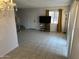 Open living room with tile flooring, a large window, and a staircase in the background at 4650 E Wood St, Phoenix, AZ 85040