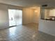 Bright living room featuring tiled floors, sliding glass doors, and decorative chandelier at 4650 E Wood St, Phoenix, AZ 85040