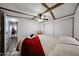 Cozy bedroom with wood beam ceiling, ceiling fan, and comfortable looking bed at 652 S Ellsworth Rd # 92, Mesa, AZ 85208