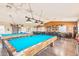 A well-lit game room with multiple pool tables and a variety of seating options at 652 S Ellsworth Rd # 92, Mesa, AZ 85208