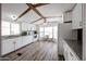 Bright kitchen features white cabinetry, granite countertops, wood-look flooring, and a cozy breakfast nook at 652 S Ellsworth Rd # 92, Mesa, AZ 85208