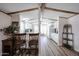 Open concept kitchen featuring wood beam accents, stainless steel appliances, and breakfast bar seating at 652 S Ellsworth Rd # 92, Mesa, AZ 85208