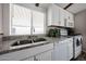 Bright kitchen featuring granite countertops, stainless steel sink, and white appliances at 652 S Ellsworth Rd # 92, Mesa, AZ 85208