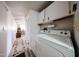 Efficient laundry room with in-unit washer and dryer connections plus extra storage shelving at 652 S Ellsworth Rd # 92, Mesa, AZ 85208