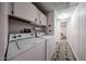 Functional laundry area with side by side washer and dryer hookups plus overhead storage at 652 S Ellsworth Rd # 92, Mesa, AZ 85208