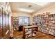 A charming library with shelves filled with books, natural light, and comfortable seating at 652 S Ellsworth Rd # 92, Mesa, AZ 85208
