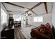 Open-concept living room with wood-look flooring that opens to the kitchen at 652 S Ellsworth Rd # 92, Mesa, AZ 85208