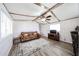 Cozy living room featuring wood-look flooring, ceiling fan, and a comfortable sofa at 652 S Ellsworth Rd # 92, Mesa, AZ 85208