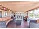 Spacious covered patio with comfortable seating, fire table, and stylish decor for outdoor living at 652 S Ellsworth Rd # 92, Mesa, AZ 85208