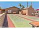 Outdoor shuffleboard courts, benches, and seating in a beautifully maintained community space at 652 S Ellsworth Rd # 92, Mesa, AZ 85208