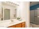 Bathroom featuring double sink vanity and shower and tub combo with sliding glass doors at 750 S Cholla St, Gilbert, AZ 85233