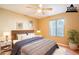 Serene bedroom features a comfortable bed, ceiling fan, and a bright window at 750 S Cholla St, Gilbert, AZ 85233