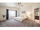 Spacious bedroom features a vaulted ceiling, large window with blue curtains, and a king bed with plush bedding at 750 S Cholla St, Gilbert, AZ 85233