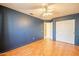 Bedroom with hardwood floors, closet, ceiling fan, and blue accent wall at 750 S Cholla St, Gilbert, AZ 85233